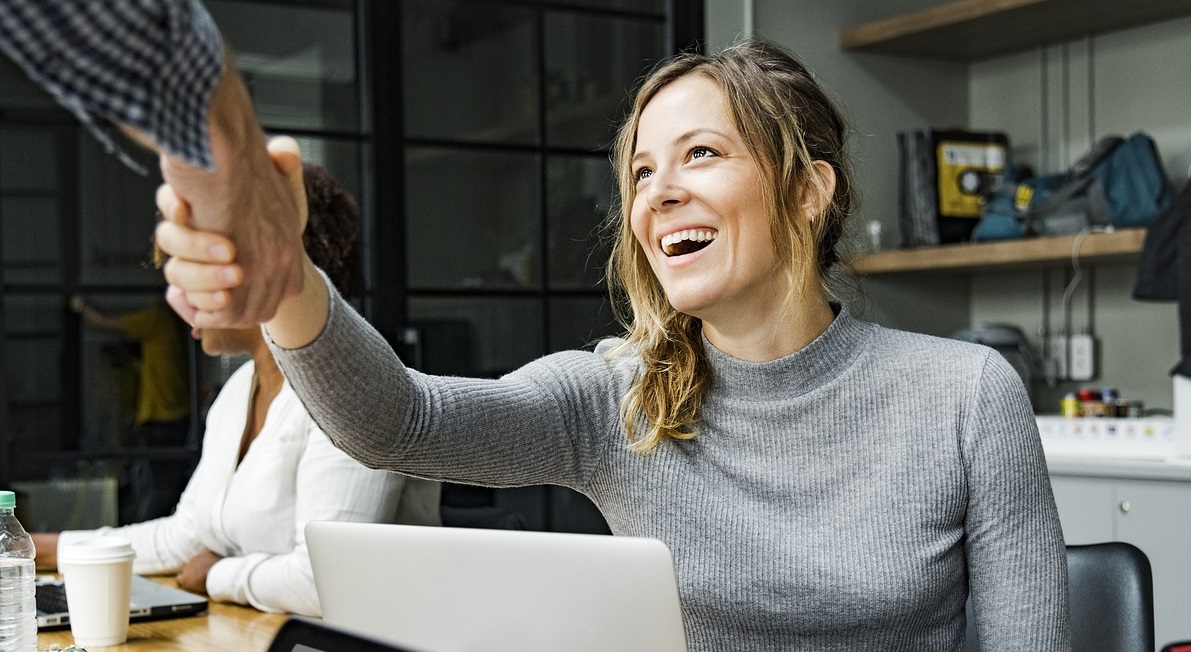 woman shaking someone's hand